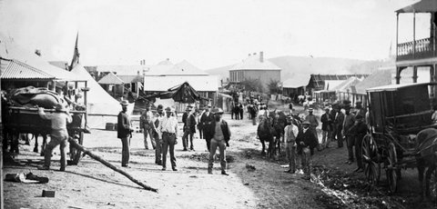 Clarke Street looking south with Captain Gus Pierce's Great Varieties Theatre (tent show, left) and Merlin's photographic cart (right), Hill EndHoltermann Collection, ON 4 Box 10 No 70133